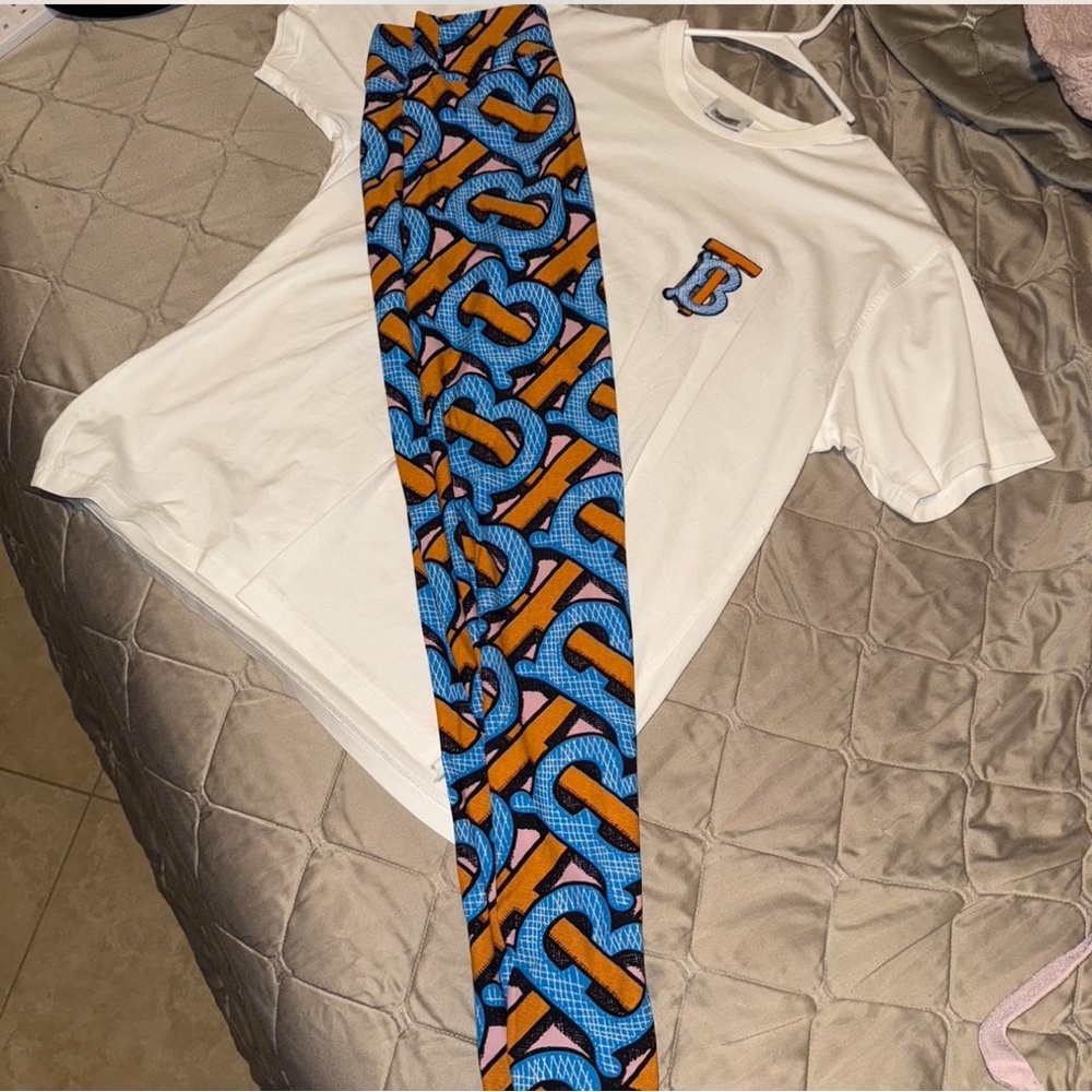 Burberry White Tee with Blue and Orange Patterned Pants